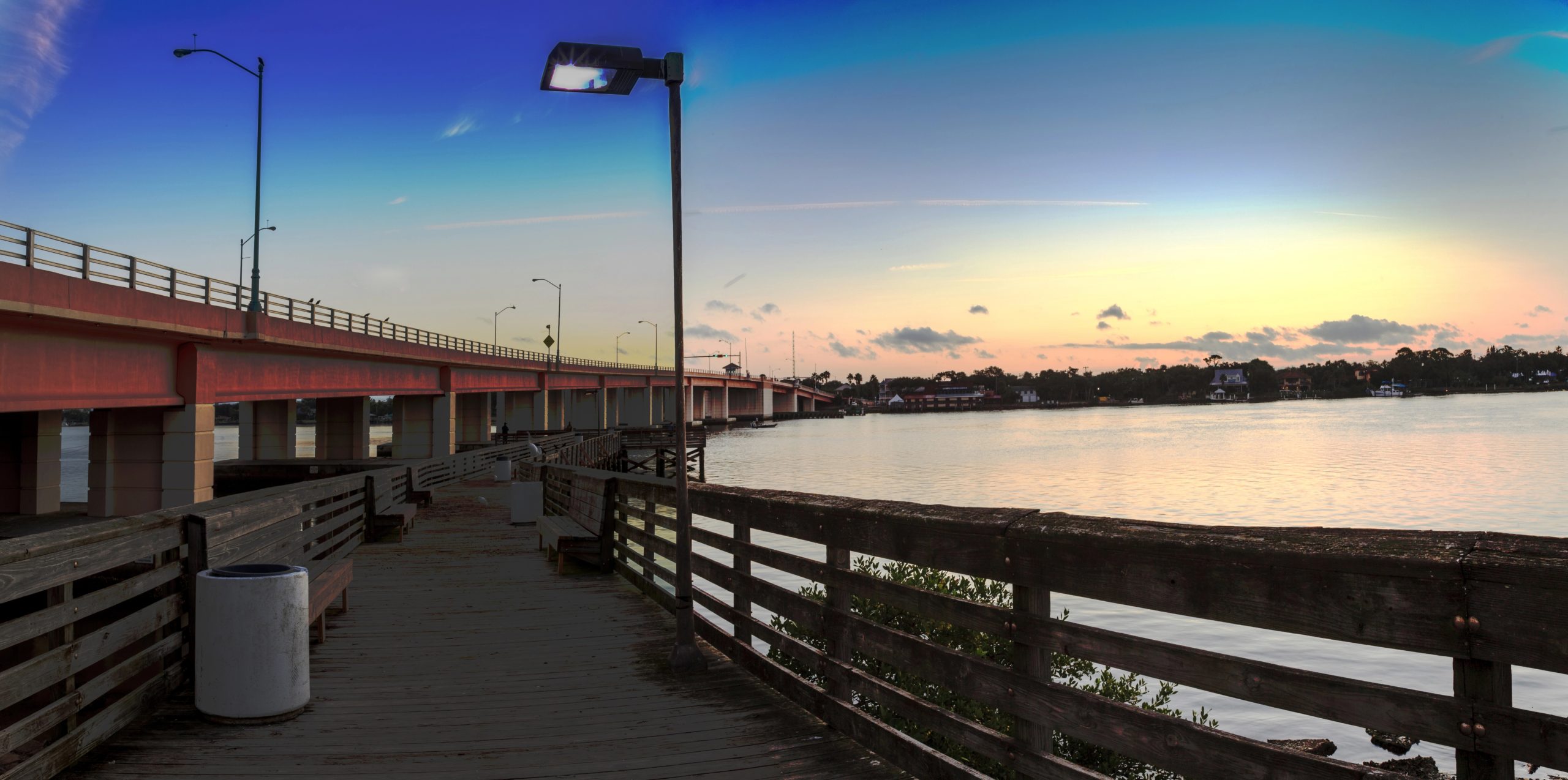 Fishing pier waterfront view at dawn over the Indian River in New Smyrna Beach, Florida.